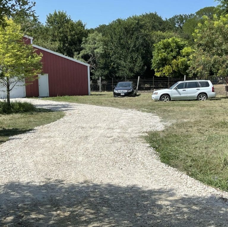 Countryside wearhouse exyterior. View of entrance and gravel driveway near Austin Texas